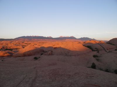 Last rays of the setting sun enlightens La Sal Mountains south of Moab, Utah