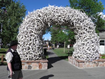 Tim at one the four elk antler gates to town square in Jackson, Wyoming.